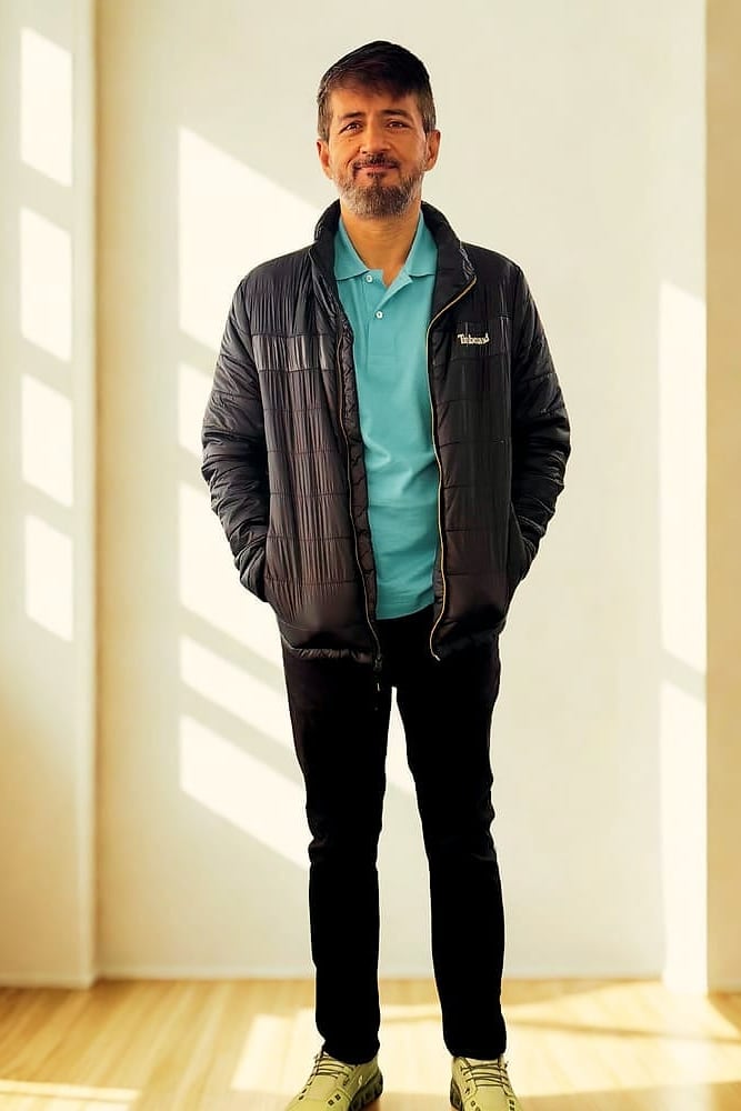 Waqas Khan Pitafi in a sunlit room, full-length portrait